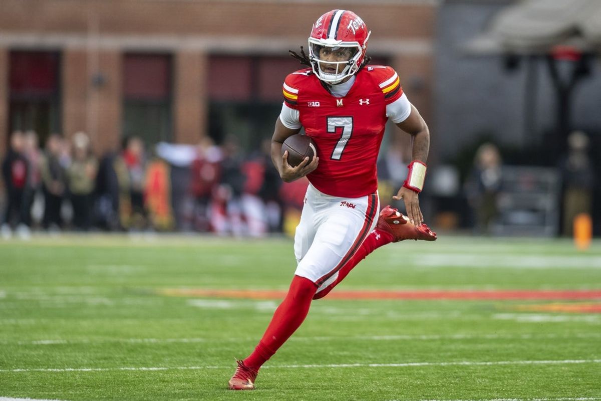 Nov 22, 2025; College Park, Maryland, USA;  Maryland Terrapins quarterback Malik Washington (7) scrambles during the first quarter against the Michigan Wolverines at SECU Stadium. Mandatory Credit: Tommy Gilligan-Imagn Images