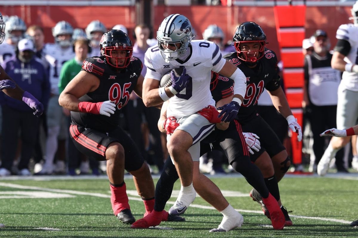 Nov 22, 2025; Salt Lake City, Utah, USA; Kansas State Wildcats tight end Linkon Cure (0) runs after a catch as Utah Utes defensive tackle Aliki Vimahi (95) and defensive tackle Jonah Lea'Ea (91) defend during the first quarter at Rice-Eccles Stadium. Mandatory Credit: Rob Gray-Imagn Images