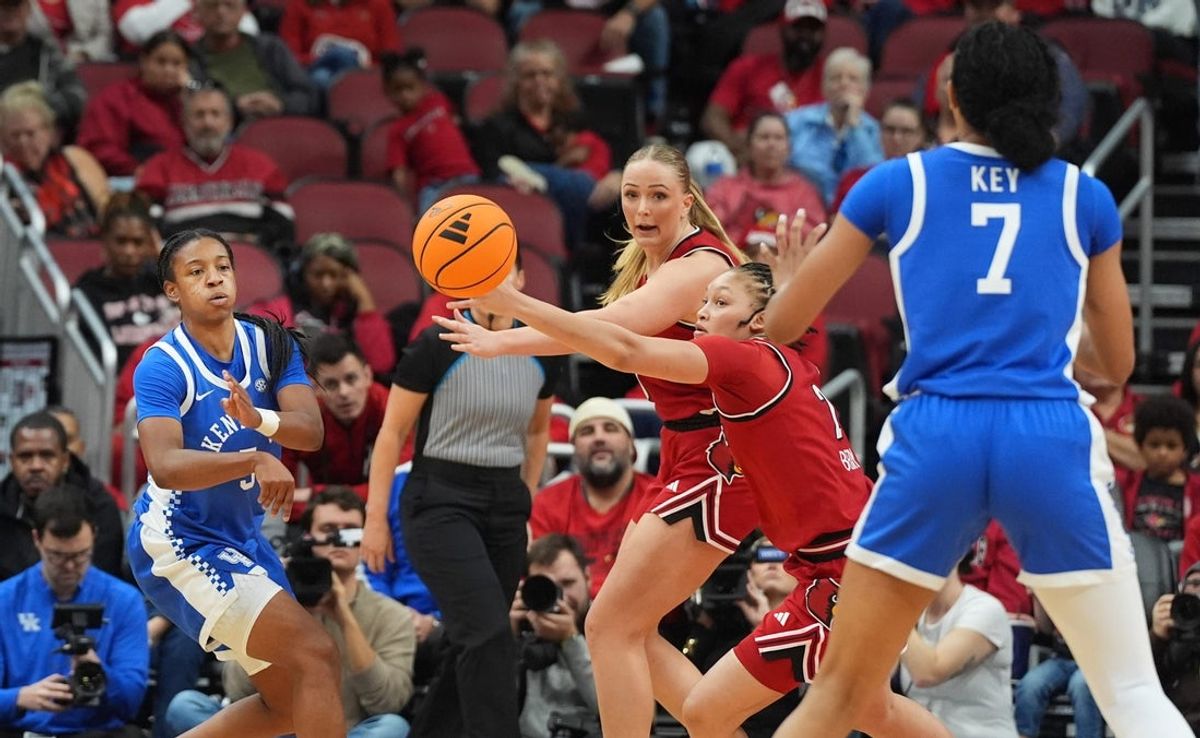Kentucky's guard Tonie Morgan (5) passes the ball to forward Teonni Key (7) against Louisville in the KFC Yum! Center. 
November 22, 2025