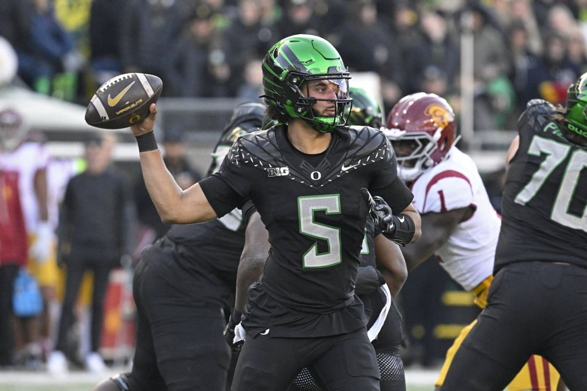 Nov 22, 2025; Eugene, Oregon, USA; Oregon Ducks quarterback Dante Moore (5) throws a pass against the Southern California Trojans during the second half at Autzen Stadium. Mandatory Credit: Troy Wayrynen-Imagn Images