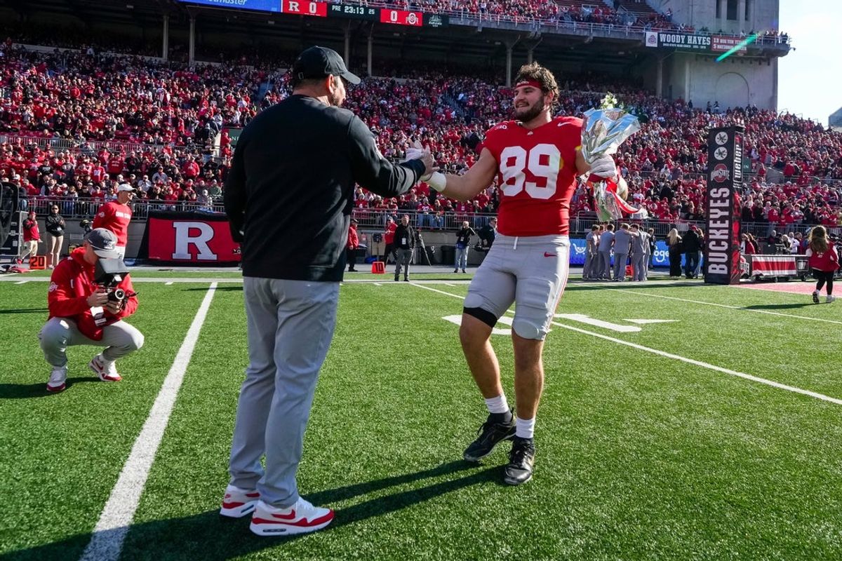 Ohio State Buckeyes tight end Will Kacmarek (89) shakes hands with head coach Ryan Day during senior day honors prior to the NCAA football game against the Rutgers Scarlet Knights at Ohio Stadium in Columbus on Nov. 22, 2025. Ohio State won 42-9.