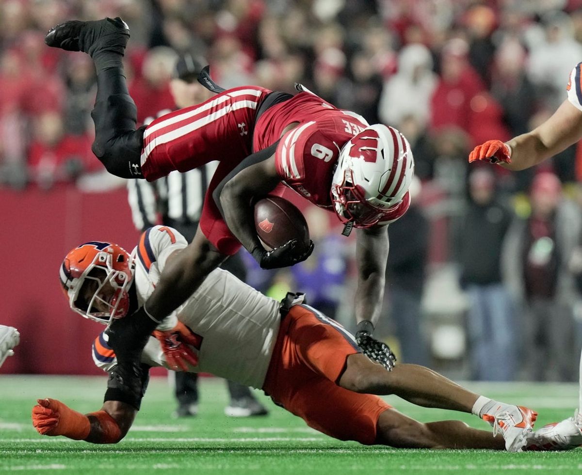 Wisconsin running back Darrion Dupree (6) is tackled by Illinois defensive back Matthew Bailey (7) during the first quarter of their game Saturday, November 22, 2025 at Camp Randall Stadium in Madison, Wisconsin.