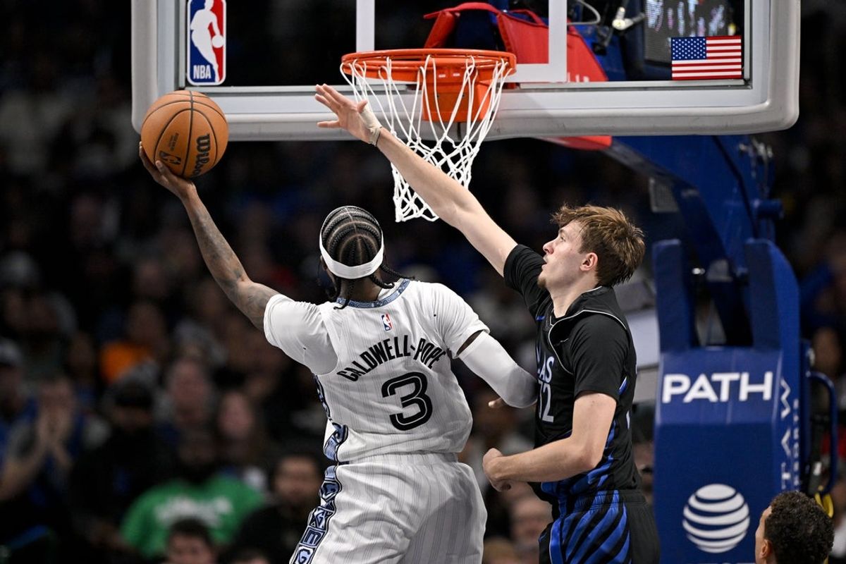 Nov 22, 2025; Dallas, Texas, USA; Memphis Grizzlies guard Kentavious Caldwell-Pope (3) shoots the ball past Dallas Mavericks forward Cooper Flagg (32) during the second quarter at the American Airlines Center. Mandatory Credit: Jerome Miron-Imagn Images