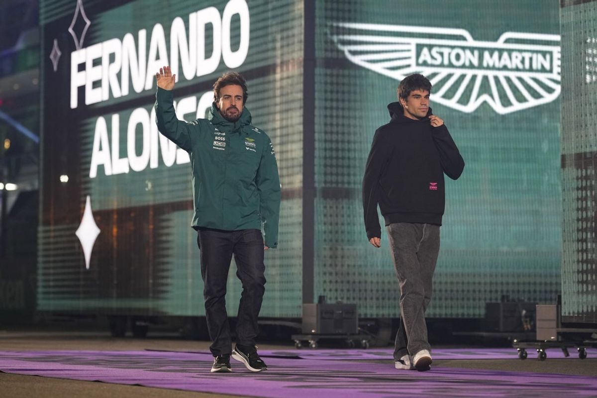 Nov 22, 2025; Las Vegas, NV, USA; Aston Martin Racing driver Fernando Alonso (14), left, and Aston Martin Racing driver Lance Stroll (18) arrive for the Las Vegas Grand Prix drivers parade at the Las Vegas Strip Circuit. Mandatory Credit: Lucas Peltier-Imagn Images