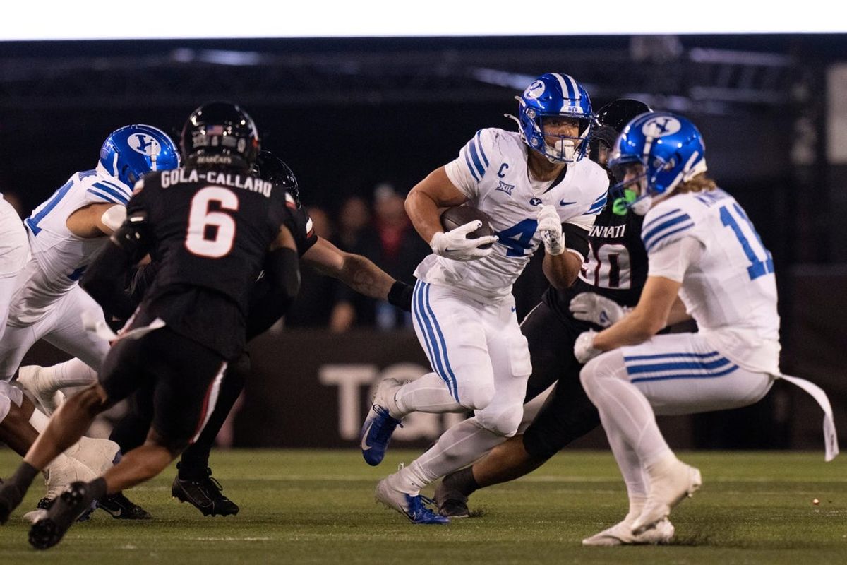 BYU Cougars running back LJ Martin (4) runs with the ball in the second quarter of the NCAA football game between the Cincinnati Bearcats and BYU Cougars at Nippert Stadium in Cincinnati on Nov. 22, 2025.