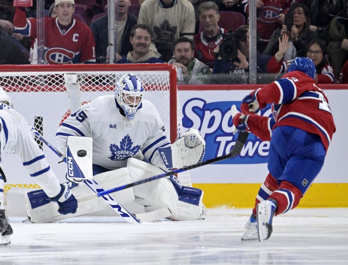 Nov 22, 2025; Montreal, Quebec, CAN; Toronto Maple Leafs goalie Dennis Hildeby (35) makes a save against Montreal Canadiens forward Cole Caufield (13) during the third period at the Bell Centre. Mandatory Credit: Eric Bolte-Imagn Images
