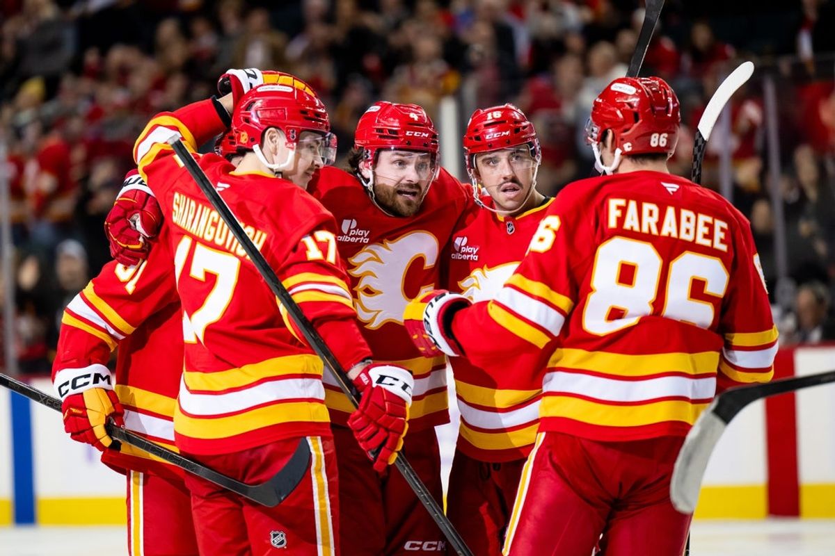 Nov 22, 2025; Calgary, Alberta, CAN; Calgary Flames left wing Joel Farabee (86) celebrates a goal against the Dallas Stars with Calgary Flames center Yegor Sharangovich (17), Calgary Flames defenseman Rasmus Andersson (4), Calgary Flames center Morgan Frost (16) and Calgary Flames center Nazem Kadri (91) during the third period at Scotiabank Saddledome. Mandatory Credit: Brett Holmes-Imagn Images