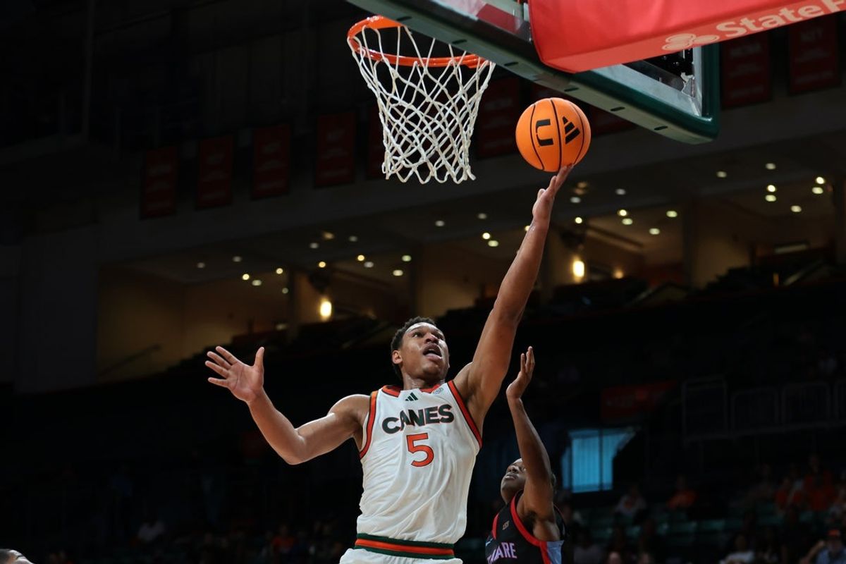 Nov 23, 2025; Coral Gables, Florida, USA; Miami Hurricanes forward Malik Reneau (5) lays up a shot against the Delaware State Hornets during the first half at Watsco Center. Mandatory Credit: Sam Navarro-Imagn Images