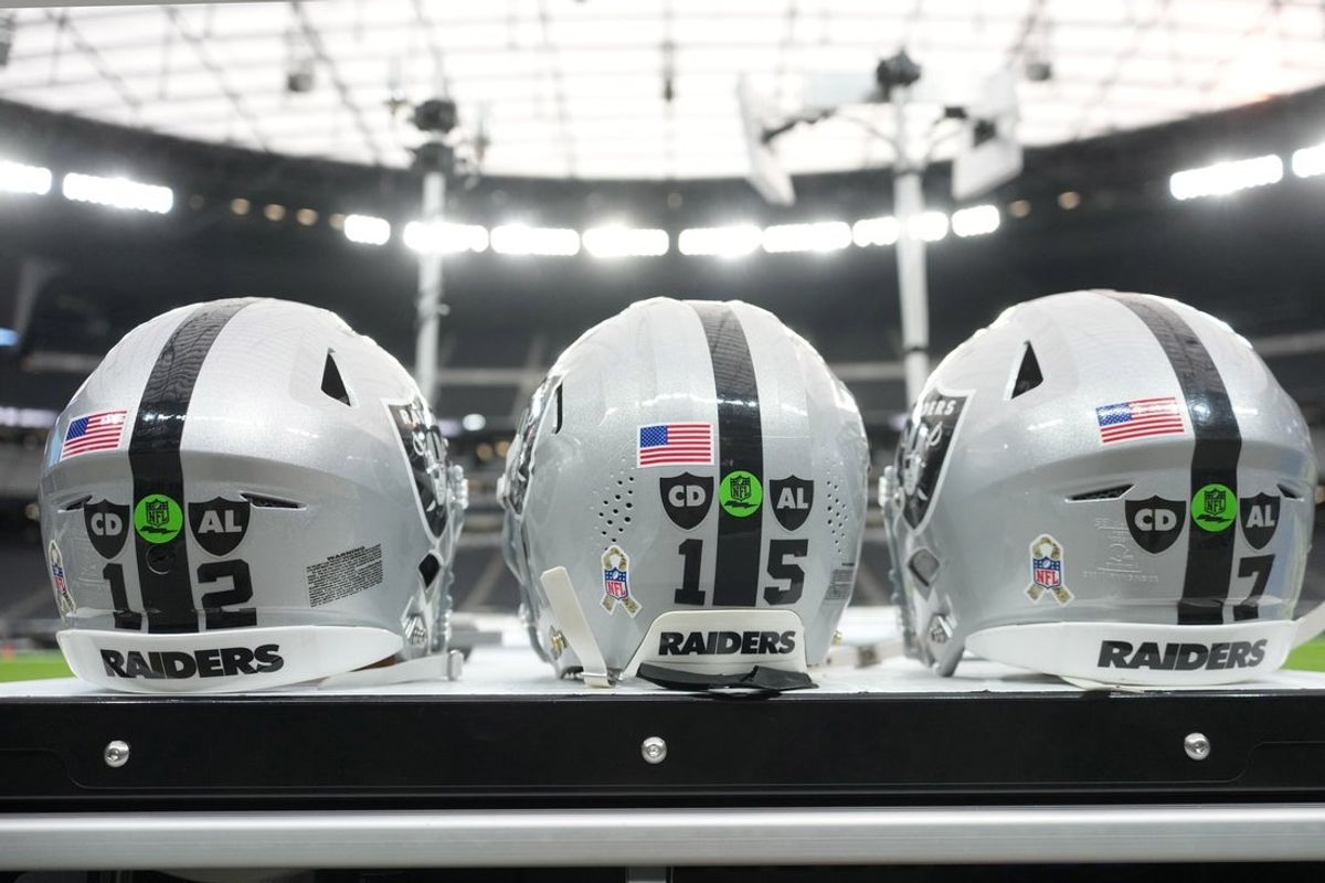 Nov 23, 2025; Paradise, Nevada, USA; The Las Vegas Raiders helmets of Las Vegas Raiders quarterback Aidan O'Connell (12), quarterback Kenny Pickett (15) and quarterback Geno Smith (7) with the Salute to Service decals and emblems honoring Al Davis and Carol Davis at Allegiant Stadium. Mandatory Credit: Kirby Lee-Imagn Images