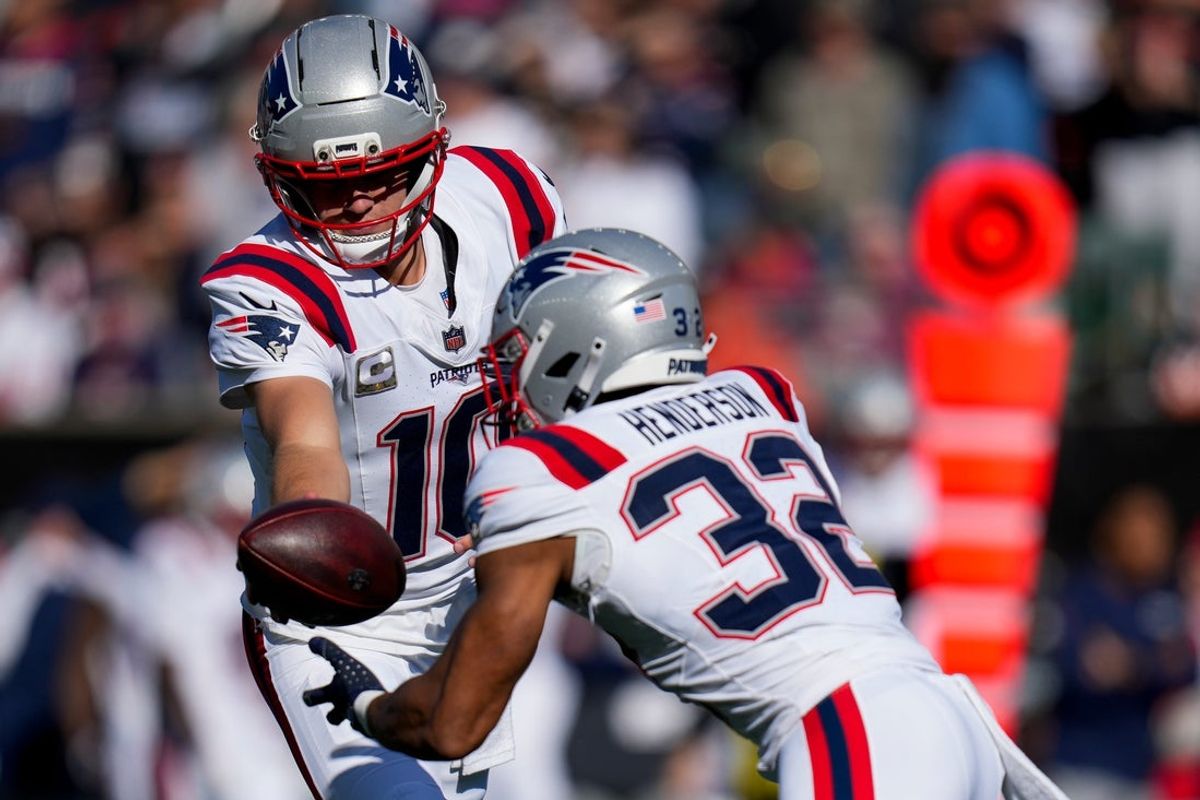 New England Patriots quarterback Drake Maye (10) hands off to running back TreVeyon Henderson (32) in the first quarter of the NFL Week 12 game between the Cincinnati Bengals and the New England Patriots at Paycor Stadium in downtown Cincinnati on Sunday, Nov. 23, 2025.