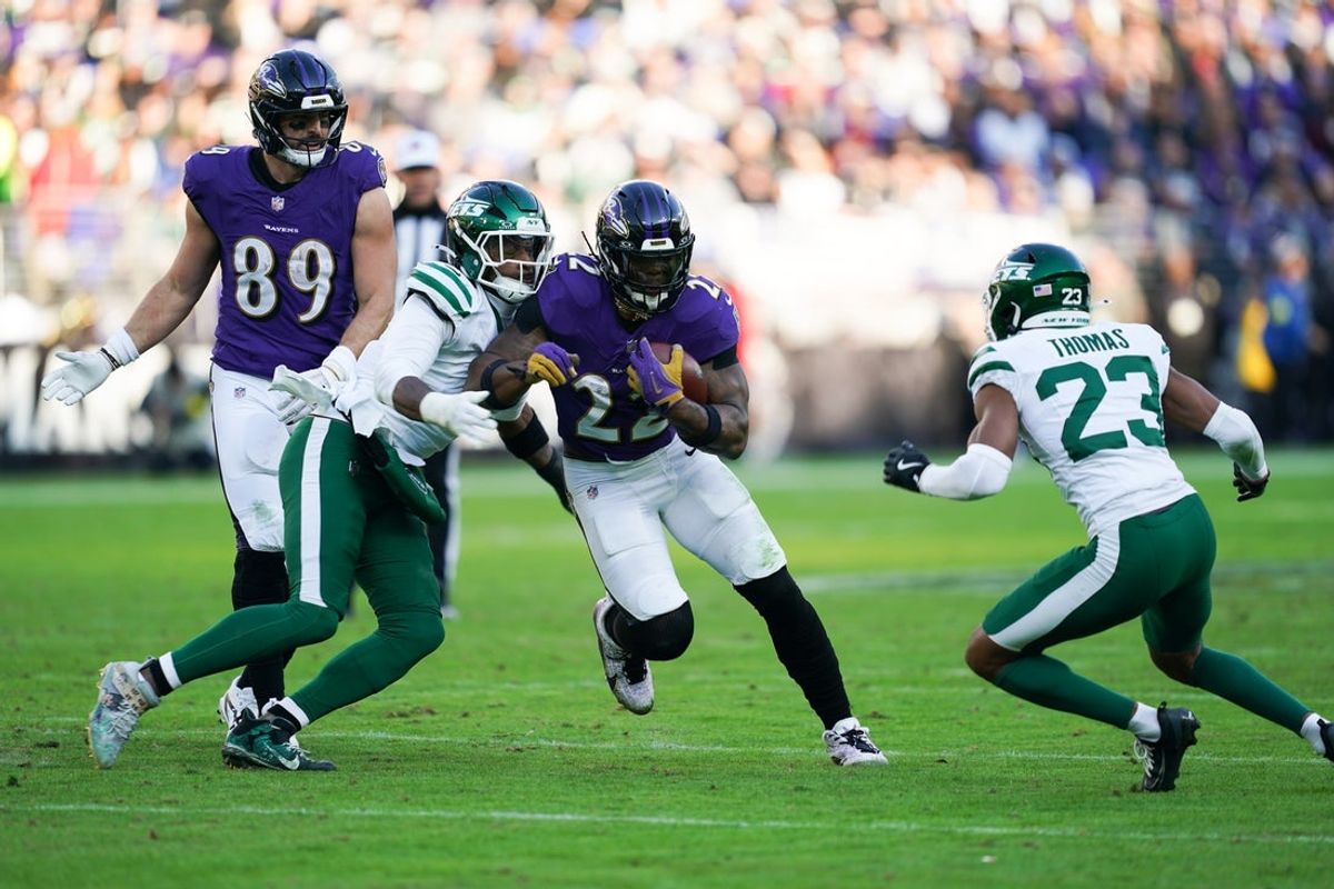 Nov 23, 2025; Baltimore, Maryland, USA; Baltimore Ravens running back Derrick Henry (22) rushes as New York Jets cornerback Azareye'h Thomas (23) defends during the third quarter at M&T Bank Stadium. Mandatory Credit: Mitch Stringer-Imagn Images