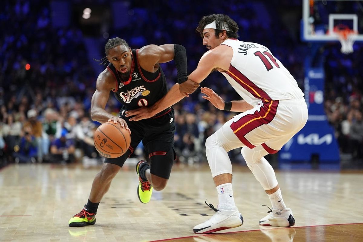 Nov 23, 2025; Philadelphia, Pennsylvania, USA; Philadelphia 76ers guard Tyrese Maxey (0) drives against Miami Heat forward Jaime Jaquez Jr. (11) in the third quarter at Xfinity Mobile Arena. Mandatory Credit: Kyle Ross-Imagn Images