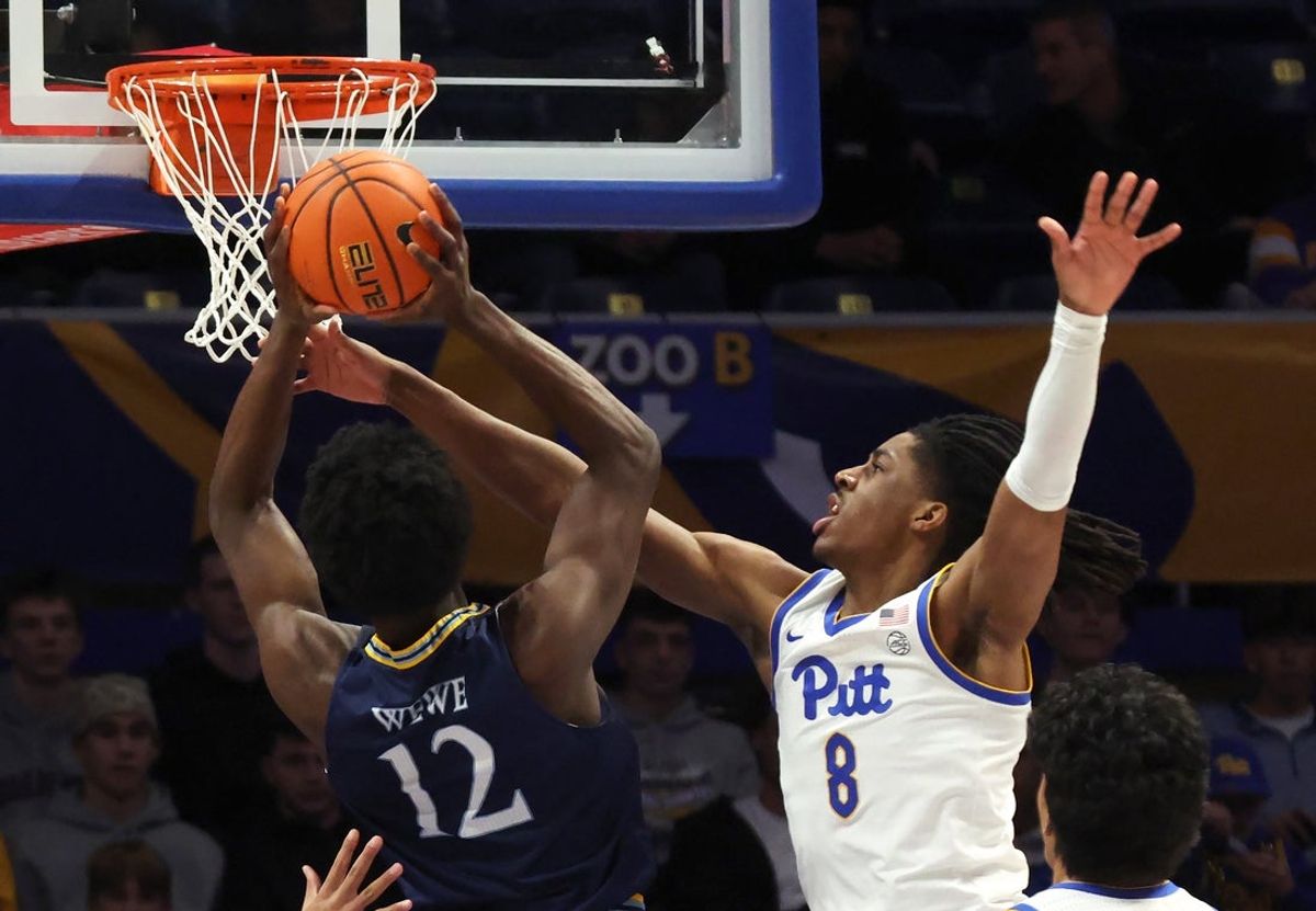 Nov 23, 2025; Pittsburgh, Pennsylvania, USA;  Pittsburgh Panthers guard Omari Witherspoon (8) fouls Quinnipiac Bobcats forward Spence Wewe (12) during the first half against at the Petersen Events Center. Mandatory Credit: Charles LeClaire-Imagn Images