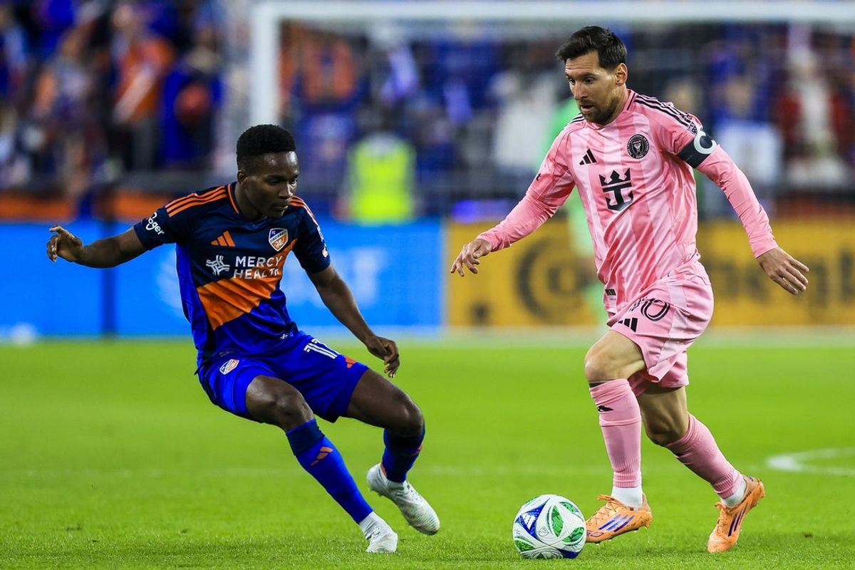 Nov 23, 2025; Cincinnati, Ohio, USA; Inter Miami CF forward Lionel Messi (10) dribbles against FC Cincinnati midfielder Samuel Gidi (11) in the first half at TQL Stadium. Mandatory Credit: Katie Stratman-Imagn Images