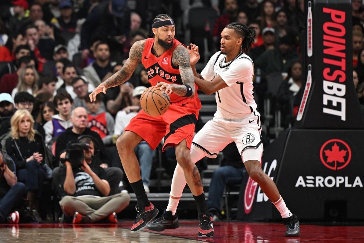 Nov 23, 2025; Toronto, Ontario, CAN;  Toronto Raptors forward Brandon Ingram (3) looks for a way past Brooklyn Nets forward Ziaire Williams (1) in the first half at Scotiabank Arena. Mandatory Credit: Dan Hamilton-Imagn Images