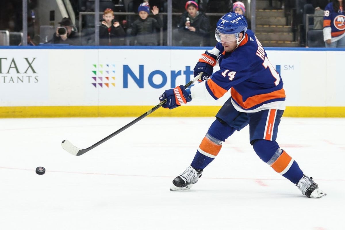 Nov 23, 2025; Elmont, New York, USA;  New York Islanders center Bo Horvat (14) goes in for a shot on goal during a shootout in overtime against the Seattle Kraken at UBS Arena. Mandatory Credit: Wendell Cruz-Imagn Images