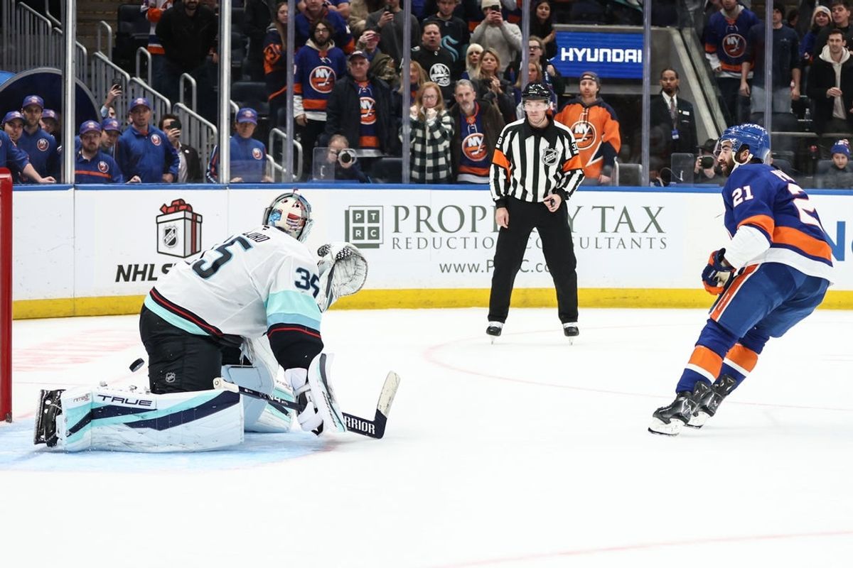 Nov 23, 2025; Elmont, New York, USA;  New York Islanders center Kyle Palmieri (21) shoots the puck past Seattle Kraken goaltender Joey Daccord (35) for the game winning shootout goal in overtime at UBS Arena. Mandatory Credit: Wendell Cruz-Imagn Images