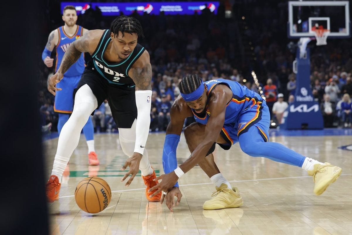 Nov 23, 2025; Oklahoma City, Oklahoma, USA; Oklahoma City Thunder guard Shai Gilgeous-Alexander (2) and Portland Trail Blazers guard Caleb Love (2) reach for a loose ball during the second quarter at Paycom Center. Mandatory Credit: Alonzo Adams-Imagn Images