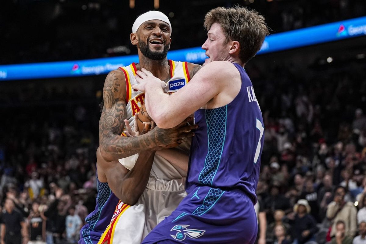 Nov 23, 2025; Atlanta, Georgia, USA; Atlanta Hawks guard Nickeil Alexander-Walker (7) fights for the ball with Charlotte Hornets guard Kon Knueppel (7) during the second half at State Farm Arena. Mandatory Credit: Dale Zanine-Imagn Images