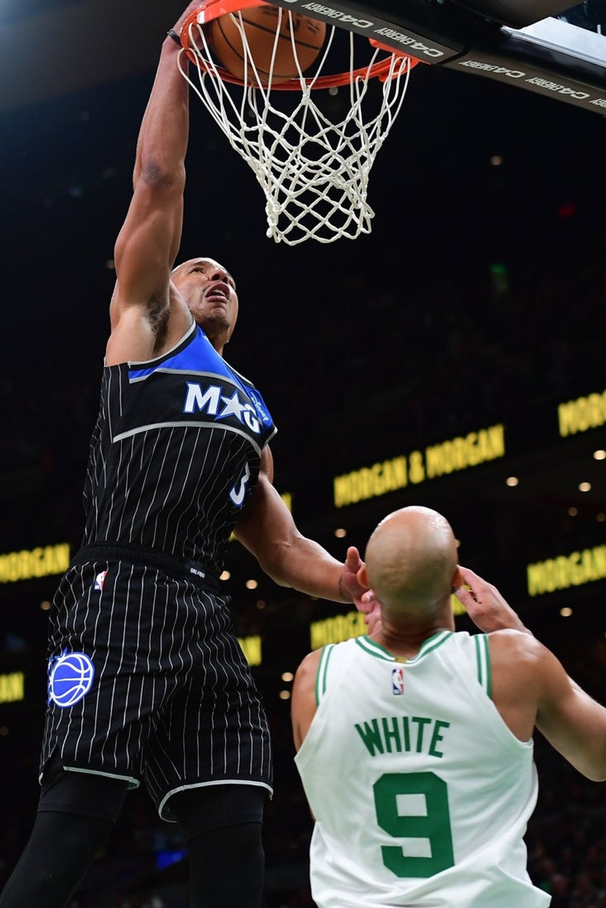 Nov 23, 2025; Boston, Massachusetts, USA; Orlando Magic guard Desmond Bane (3) dunks the ball over Boston Celtics guard Derrick White (9) during the first half at TD Garden. Mandatory Credit: Bob DeChiara-Imagn Images