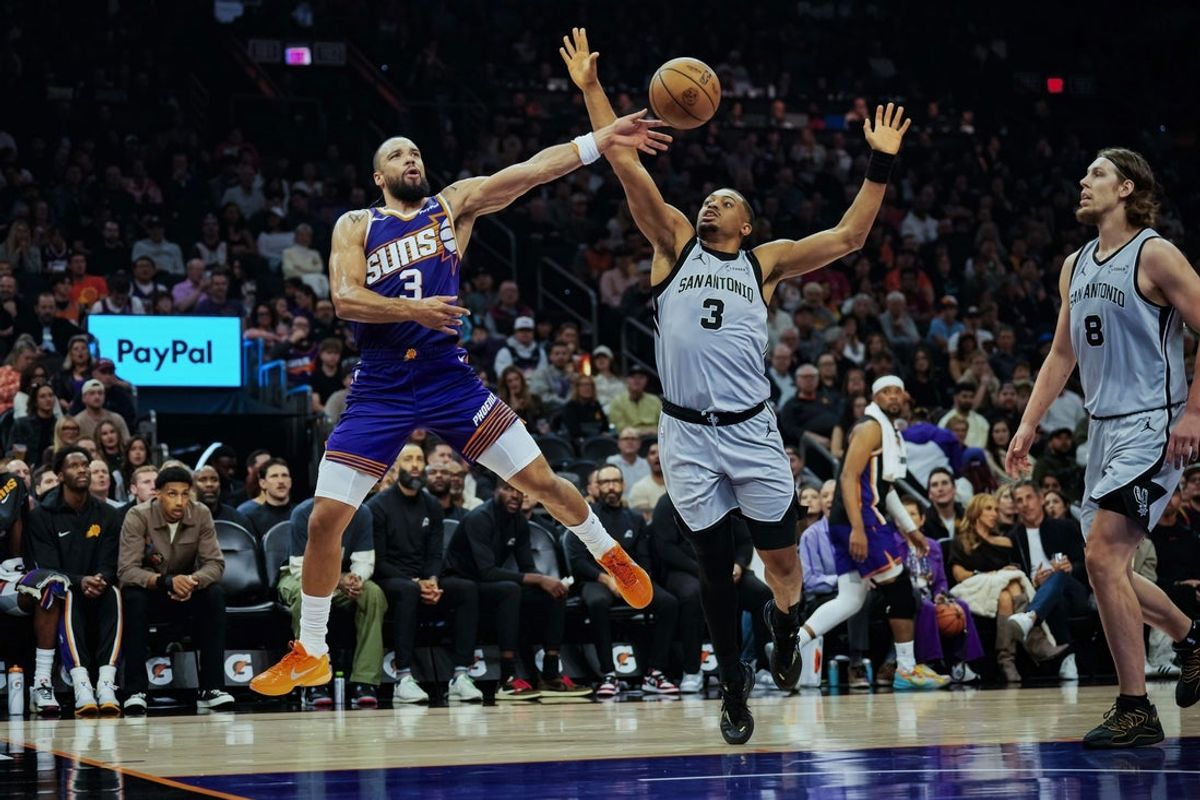 Nov 23, 2025; Phoenix, Arizona, USA; Phoenix Suns forward Dillon Brooks (3) and San Antonio Spurs forward Keldon Johnson (3) battle for the ball in the first half of the game at Mortgage Match Up Center. Mandatory Credit: Arianna Grainey-Imagn Images