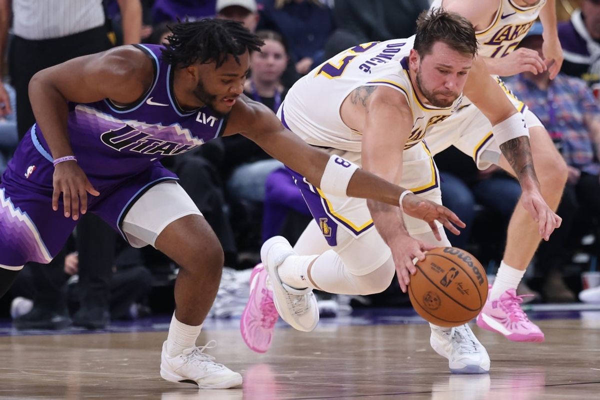 Nov 23, 2025; Salt Lake City, Utah, USA; Utah Jazz guard Isaiah Collier (8) and Los Angeles Lakers guard Luka Doncic (77) go for a loose ball during the second quarter at Delta Center. Mandatory Credit: Rob Gray-Imagn Images