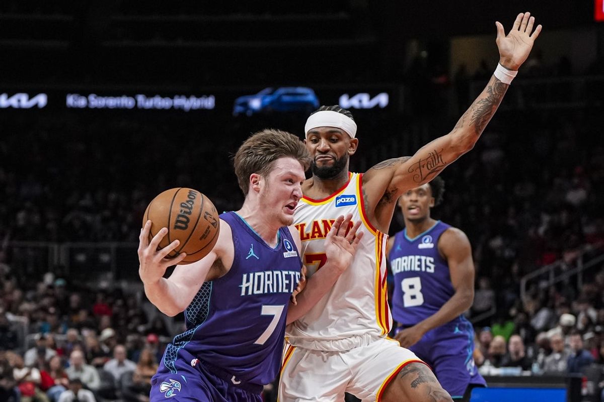 Nov 23, 2025; Atlanta, Georgia, USA; Charlotte Hornets guard Kon Knueppel (7) works against the defense of Atlanta Hawks guard Nickeil Alexander-Walker (7) during the second half at State Farm Arena. Mandatory Credit: Dale Zanine-Imagn Images