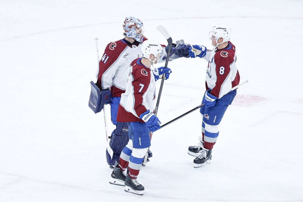 Nov 23, 2025; Chicago, Illinois, USA; Colorado Avalanche goaltender Scott Wedgewood (41), defenseman Devon Toews (7) and defenseman Cale Makar (8) celebrate after defeating the Chicago Blackhawks at United Center. Mandatory Credit: Kamil Krzaczynski-Imagn Images