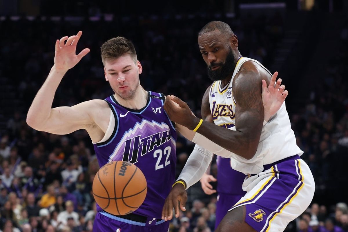 Nov 23, 2025; Salt Lake City, Utah, USA; Utah Jazz forward Kyle Filipowski (22) is fouled by Los Angeles Lakers forward LeBron James (23) during the fourth quarter at Delta Center. Mandatory Credit: Rob Gray-Imagn Images