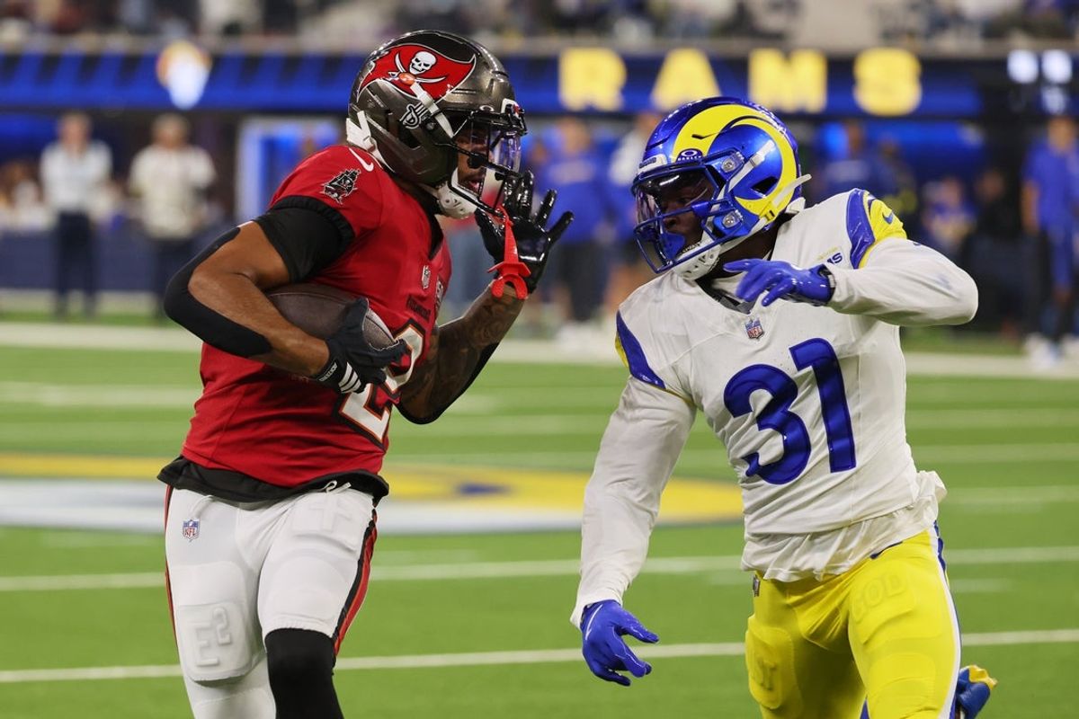 Nov 23, 2025; Inglewood, California, USA; Tampa Bay Buccaneers wide receiver Emeka Egbuka (2) runs with the ball against Los Angeles Rams cornerback Darious Williams (31) during the fourth quarter at SoFi Stadium. Mandatory Credit: Kiyoshi Mio-Imagn Images