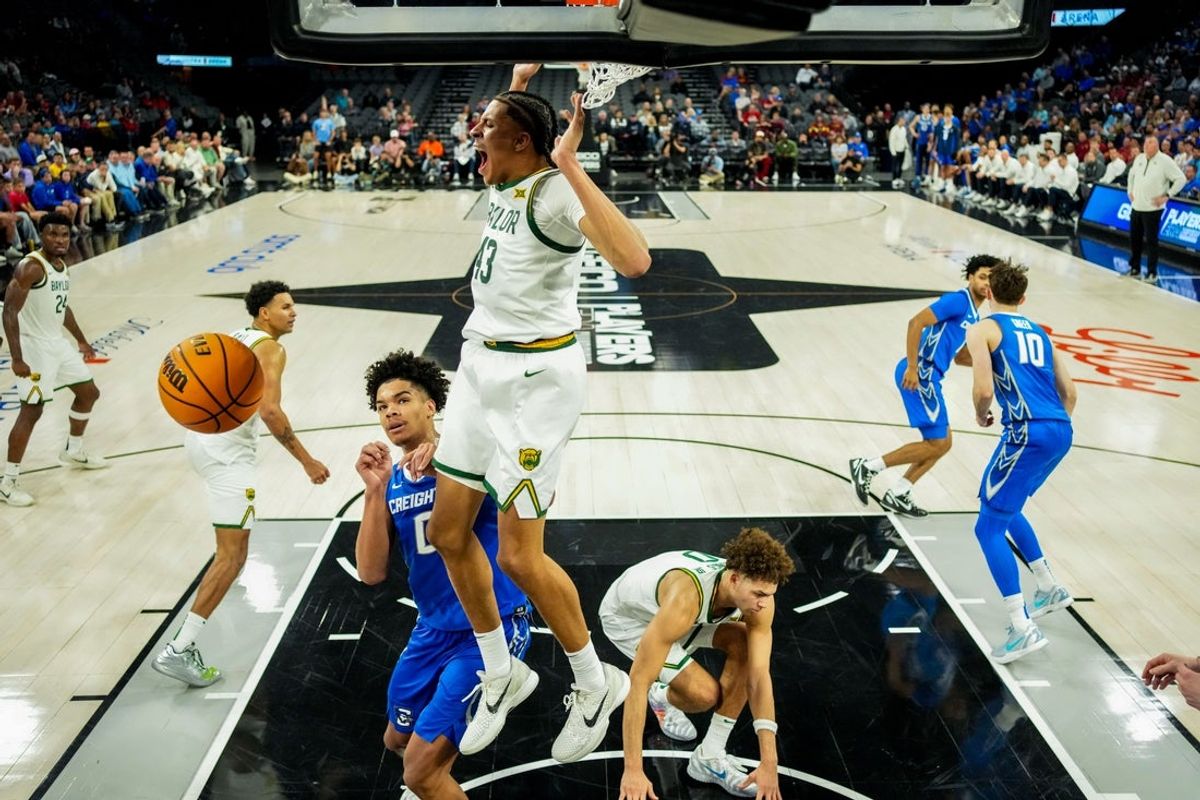 Nov 24, 2025; Las Vegas, Nevada, USA; Baylor Bears guard Cameron Carr (43) follows through in a dunk as Creighton Bluejays forward Jasen Green (0) looks on during the second half in a 2025 Players Era Festival group play game at Michelob Ultra Arena. Mandatory Credit: Kirby Lee-Imagn Images
