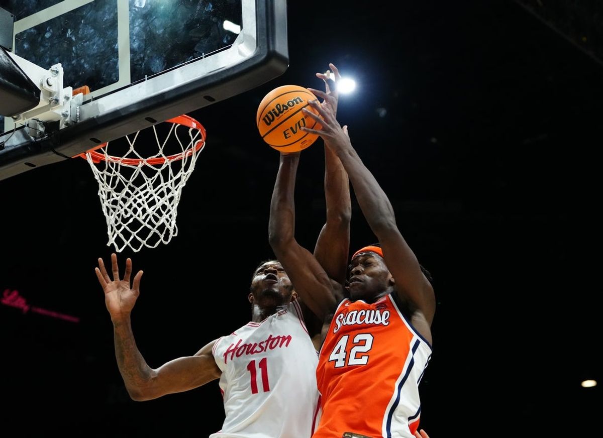 Nov 24, 2025; Las Vegas, Nevada, USA; Houston Cougars forward Joseph Tugler (11) and Syracuse Orange forward William Kyle III (42) battle for control of a rebound during the first half of a 2025 Players Era Festival group play game at MGM Grand Garden Arena. Mandatory Credit: Stephen R. Sylvanie-Imagn Images