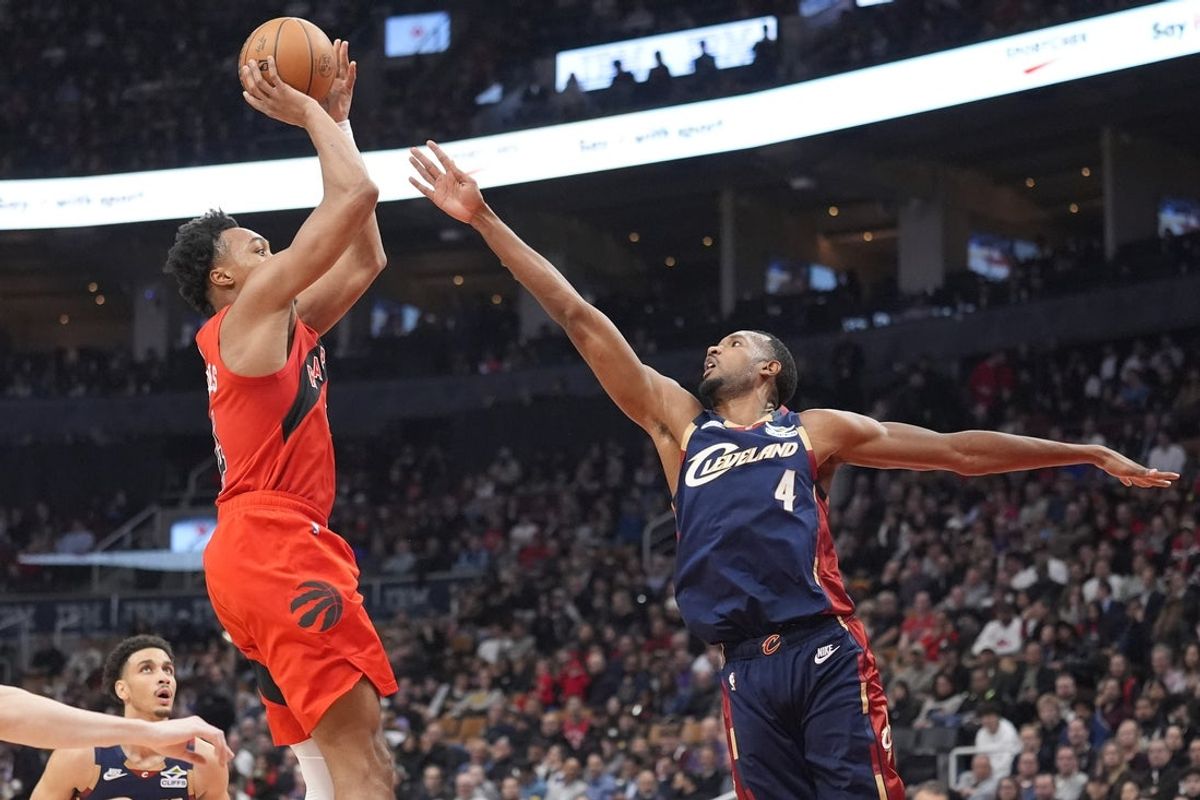 Nov 24, 2025; Toronto, Ontario, CAN; Cleveland Cavaliers forward Evan Mobley (4) defends against Toronto Raptors guard Scottie Barnes (4) during the first half at Scotiabank Arena. Mandatory Credit: John E. Sokolowski-Imagn Images