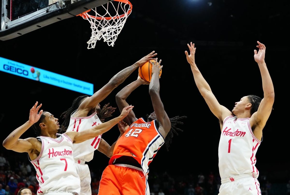 Nov 24, 2025; Las Vegas, Nevada, USA; Syracuse Orange forward William Kyle III (42) drives to the hoop past Houston Cougars forward Joseph Tugler (11), guard Milos Uzan (7) and guard Isiah Harwell (1) during the second half of a 2025 Players Era Festival group play game at MGM Grand Garden Arena. Mandatory Credit: Stephen R. Sylvanie-Imagn Images