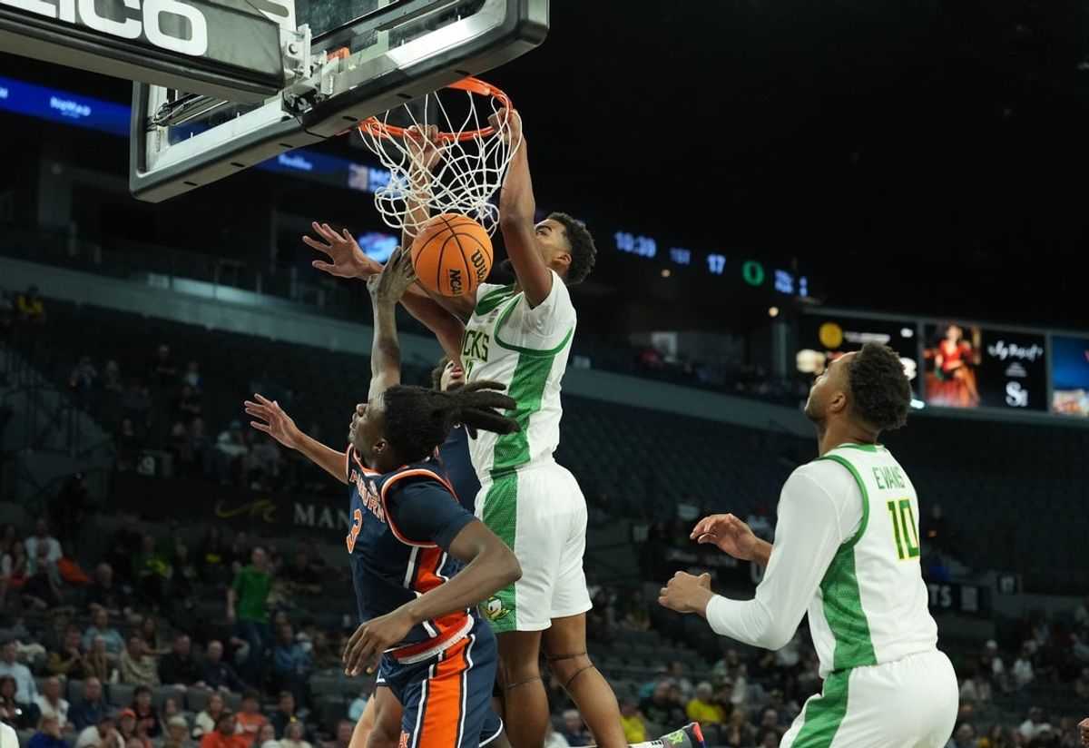 Nov 24, 2025; Las Vegas, NV, USA; Oregon Ducks forward Sean Stewart (13) drives to the hoop past Auburn Tigers forward KeShawn Murphy (3) during the first half of a 2025 Players Era Festival group play game at Michelob ULTRA Arena. Mandatory Credit: Kirby Lee-Imagn Images