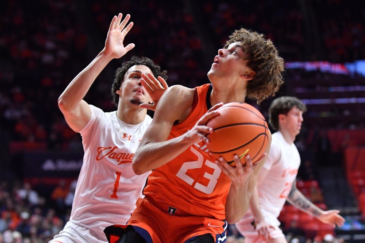 Nov 24, 2025; Champaign, Illinois, USA;  Illinois Fighting Illini guard Keaton Wagler (23) drives the ball against UT Rio Grande Valley Vaqueros guard Always Wright (1) during the first half at State Farm Center. Mandatory Credit: Ron Johnson-Imagn Images