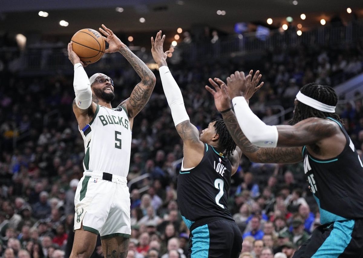 Nov 24, 2025; Milwaukee, Wisconsin, USA; Milwaukee Bucks guard Gary Trent Jr. (5) puts up a shot against Portland Trail Blazers guard Caleb Love (2) in the first half at Fiserv Forum. Mandatory Credit: Michael McLoone-Imagn Images