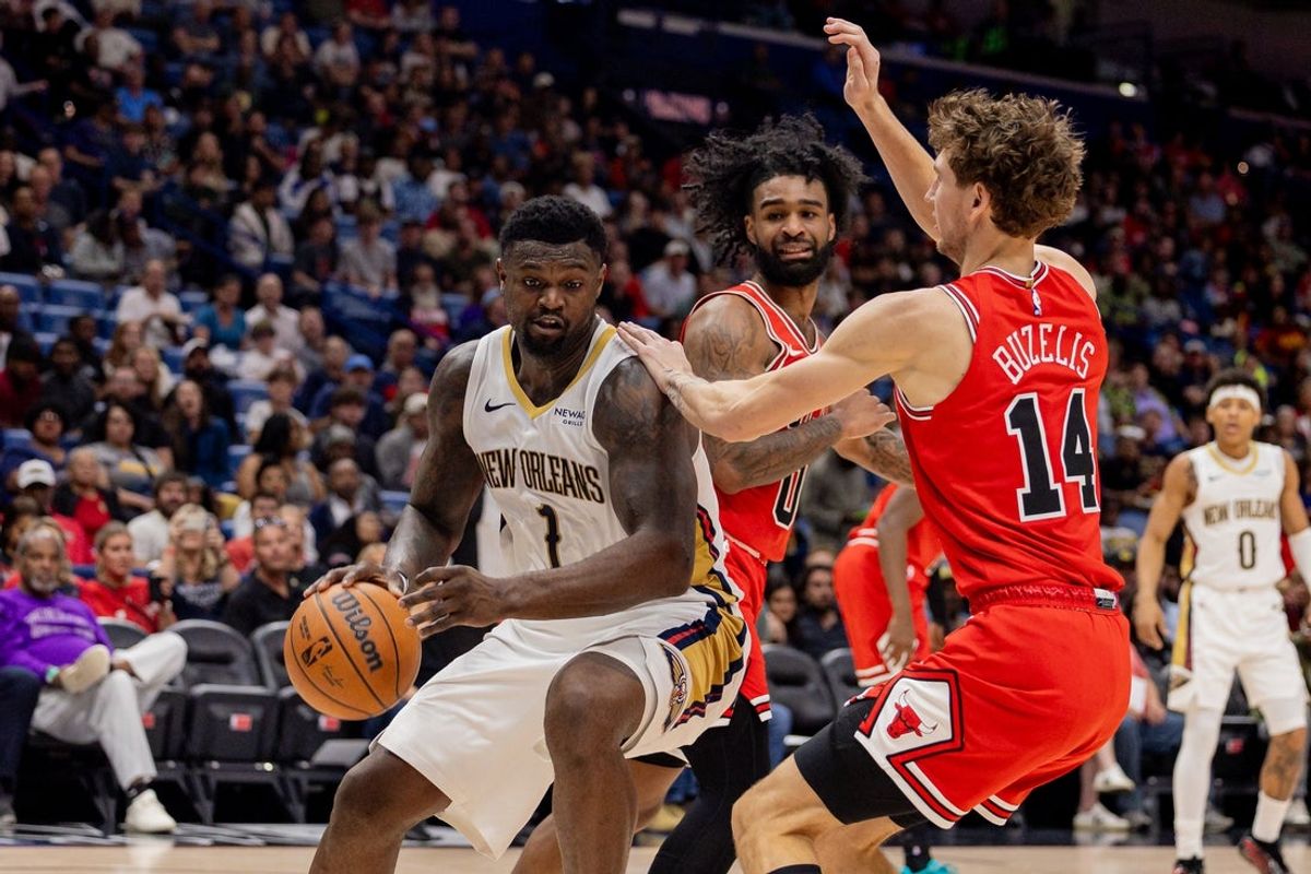 Nov 24, 2025; New Orleans, Louisiana, USA;  New Orleans Pelicans forward Zion Williamson (1) dribbles against Chicago Bulls forward Matas Buzelis (14) during the first half at Smoothie King Center. Mandatory Credit: Stephen Lew-Imagn Images
