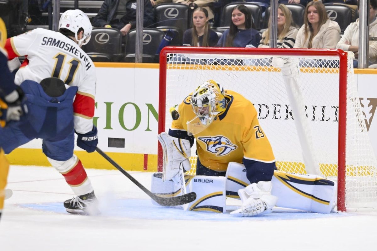 Nov 24, 2025; Nashville, Tennessee, USA;  Nashville Predators goaltender Justus Annunen (29) blocks the shot of Florida Panthers right wing Mackie Samoskevich (11) during the second period at Bridgestone Arena. Mandatory Credit: Steve Roberts-Imagn Images