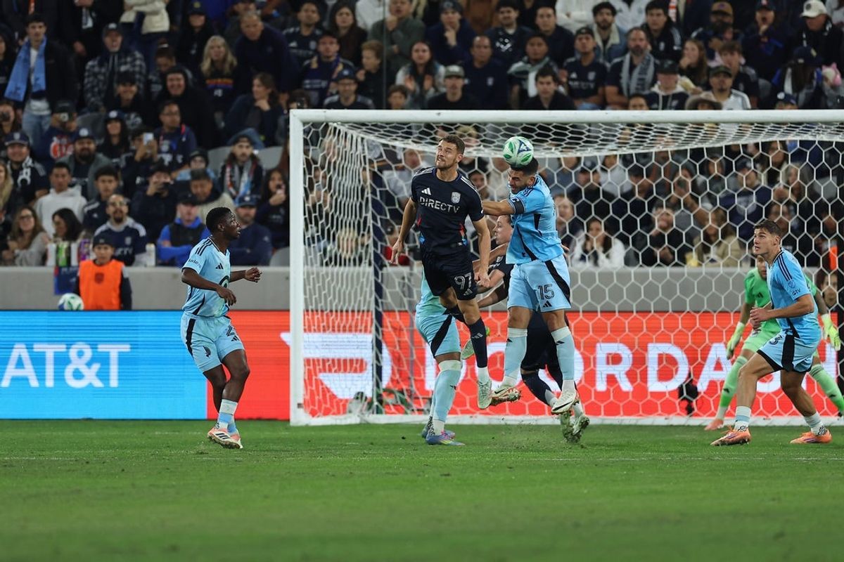 Nov 24, 2025; San Diego, California, USA; Minnesota United defender Michael Boxall (15) headers the ball against San Diego FC defender Christopher McVey (97) during the first half at Snapdragon Stadium. Mandatory Credit: Abe Arredondo-Imagn Images