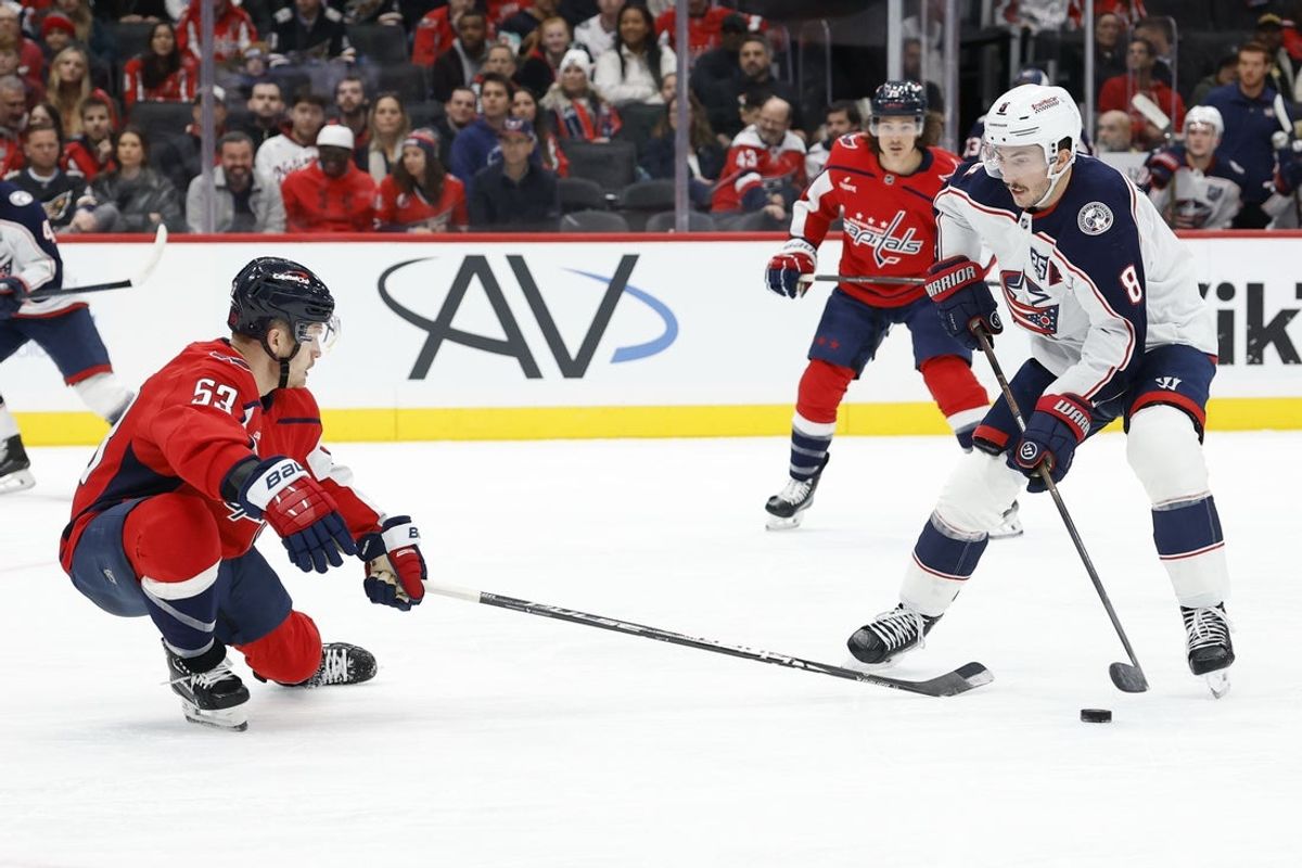 Nov 24, 2025; Washington, District of Columbia, USA; Columbus Blue Jackets defenseman Zach Werenski (8) skates with the puck against as Washington Capitals center Ethen Frank (53) defends during the second period at Capital One Arena. Mandatory Credit: Geoff Burke-Imagn Images