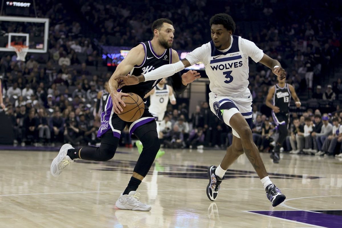 Nov 24, 2025; Sacramento, California, USA; Sacramento Kings guard Zach LaVine (8) drives towards the basket while being defended by Minnesota Timberwolves forward Jaden McDaniels (3) during the first quarter at Golden 1 Center. Mandatory Credit: Dennis Lee-Imagn Images