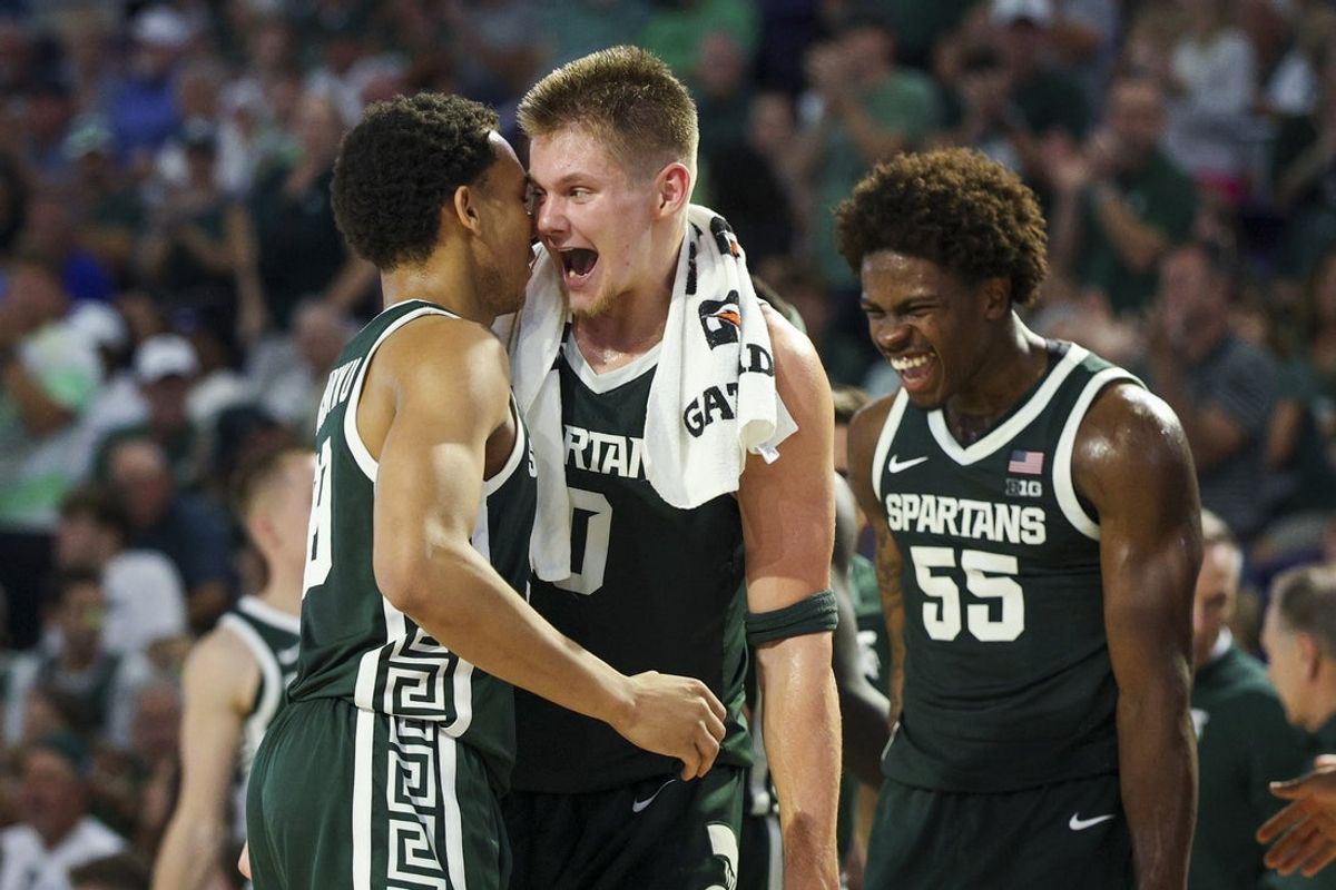 Nov 25, 2025; Fort Myers, Florida, USA; Michigan State Spartans forward Jaxon Kohler (0) reacts to guard Divine Ugochukwu (99) after a basket against the East Carolina Pirates in the first half  at Suncoast Credit Union Arena. Mandatory Credit: Nathan Ray Seebeck-Imagn Images