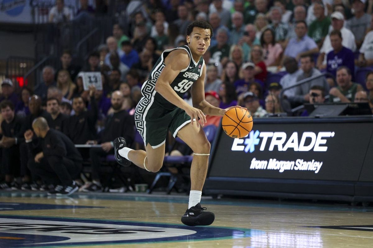 Nov 25, 2025; Fort Myers, Florida, USA; Michigan State Spartans guard Divine Ugochukwu (99) controls the ball against the East Carolina Pirates in the second half at Suncoast Credit Union Arena. Mandatory Credit: Nathan Ray Seebeck-Imagn Images