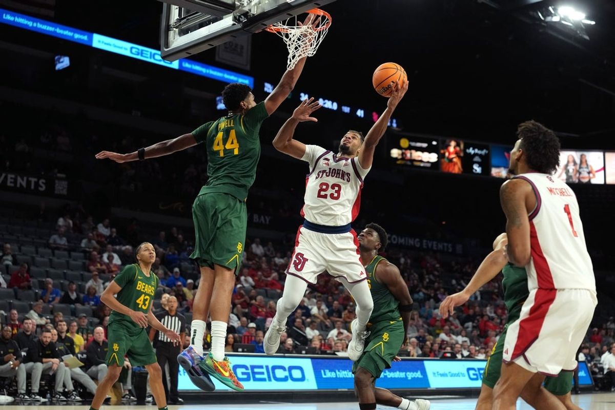 Nov 25, 2025; Las Vegas, Nevada, USA; St. John's Red Storm forward Bryce Hopkins (23) goes for a layup against Baylor Bears center Caden Powell (44) in a 2025 Players Era Festival group play game at Michelob Ultra Arena. Mandatory Credit: Kirby Lee-Imagn Images