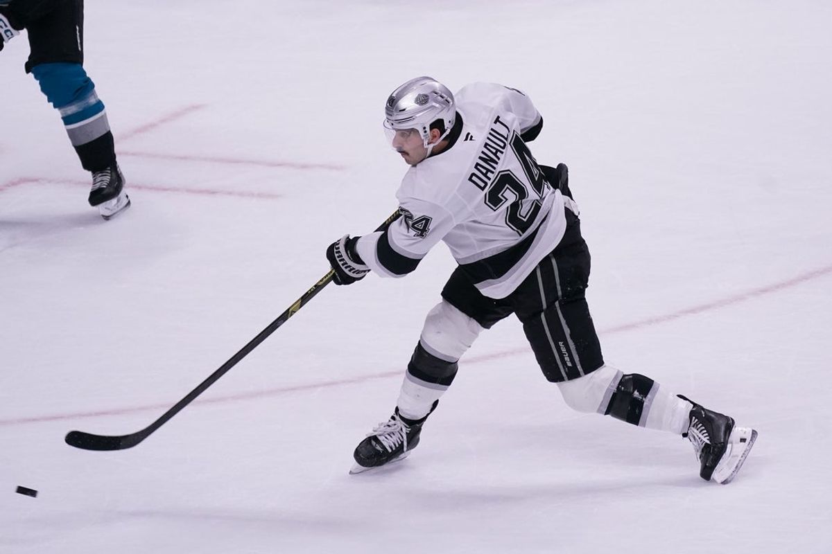 Nov 20, 2025; San Jose, California, USA;  Los Angeles Kings center Phillip Danault (24) takes a shot on goal in overtime against the San Jose Sharks at SAP Center at San Jose. Mandatory Credit: David Gonzales-Imagn Images
