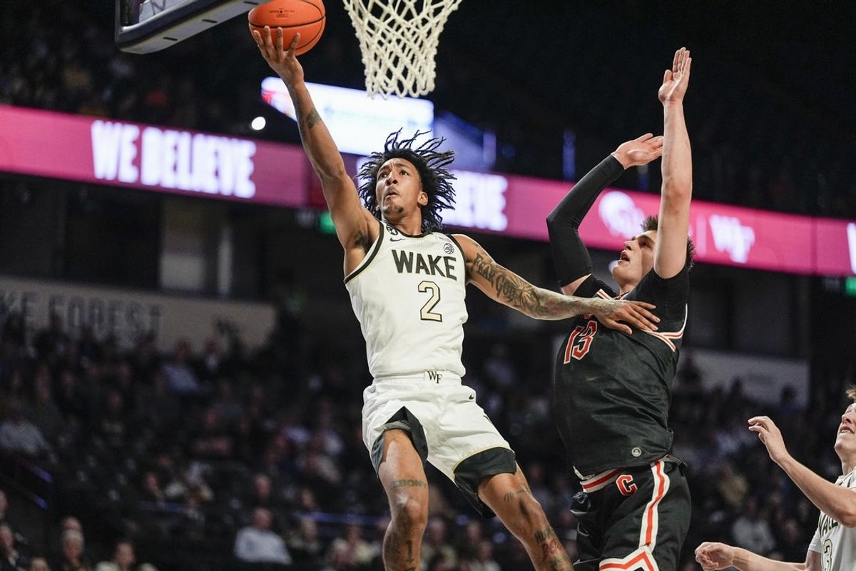 Nov 25, 2025; Winston-Salem, North Carolina, USA; Wake Forest Demon Deacons forward Juke Harris (2) drives to the basket against Campbell Fighting Camels forward Dovydas Butka (13) during the first half at Lawrence Joel Veterans Memorial Coliseum. Mandatory Credit: Jim Dedmon-Imagn Images