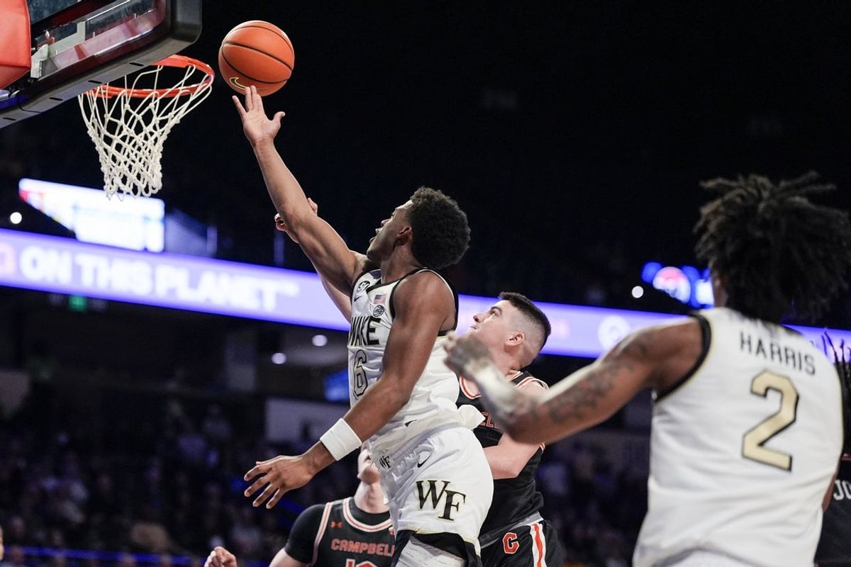 Nov 25, 2025; Winston-Salem, North Carolina, USA; Wake Forest Demon Deacons guard Myles Colvin (6) drives to the basket against Campbell Fighting Camels forward Dovydas Butka (13) during the first half at Lawrence Joel Veterans Memorial Coliseum. Mandatory Credit: Jim Dedmon-Imagn Images