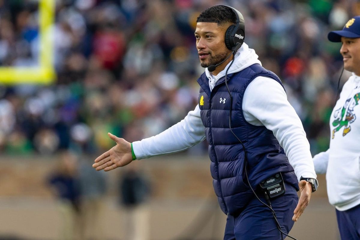 Nov 22, 2025; South Bend, Indiana, USA; Notre Dame Fighting Irish head coach Marcus Freeman celebrates with players after scoring against the Syracuse Orange during the first half at Notre Dame Stadium. Mandatory Credit: Michael Caterina-Imagn Images