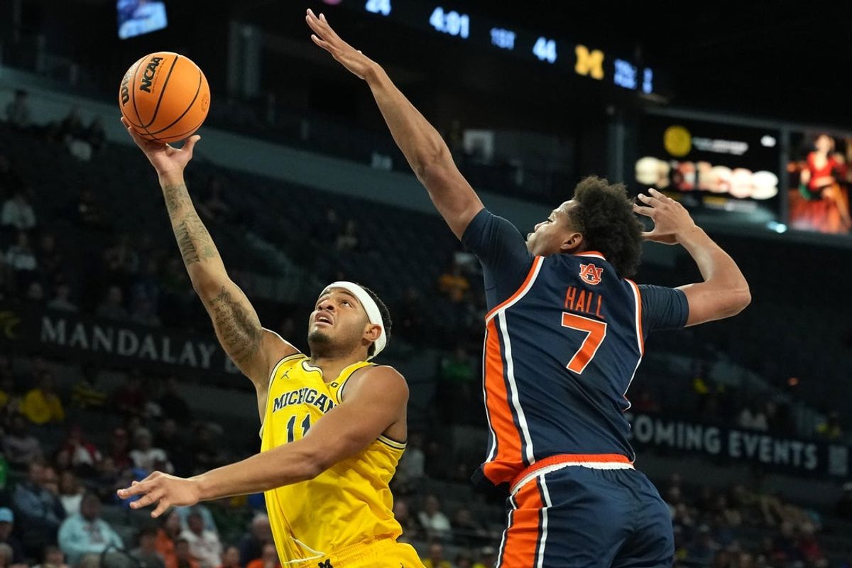 Nov 25, 2025; Las Vegas, NV, USA; Michigan Wolverines guard Roddy Gayle Jr. (11) drives to the basket against Auburn Tigers guard Keyshawn Hall (7) during the first half in a 2025 Players Era Festival group play game at Michelob ULTRA Arena. Mandatory Credit: Kirby Lee-Imagn Images